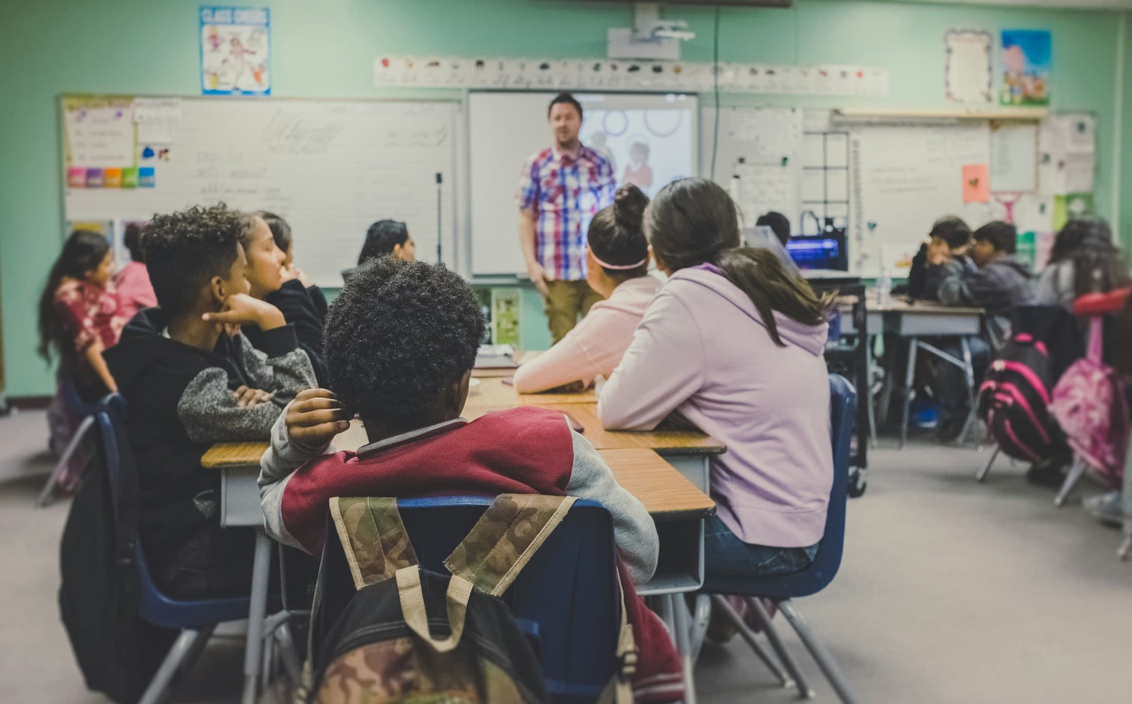Teacher working with students in a bright classroom